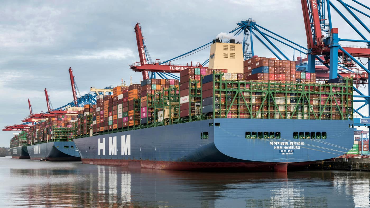 Container vessel underway carrying stacked shipping containers