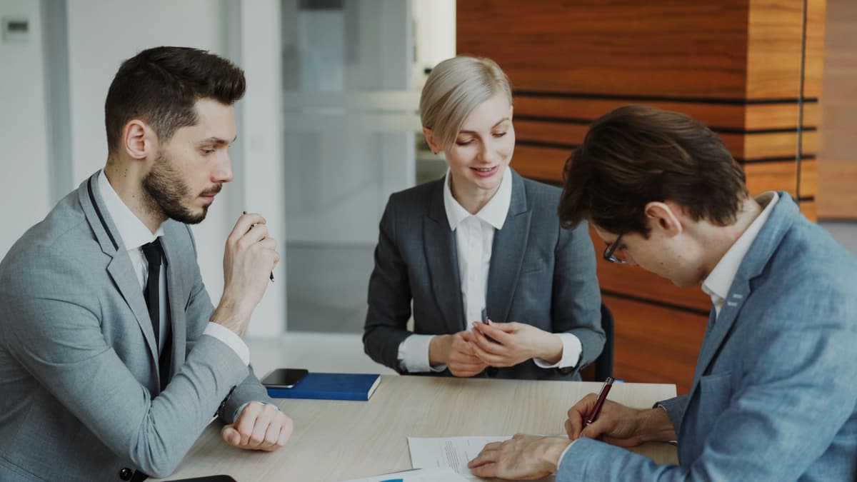 Colleagues collaborating around a table in a bright office